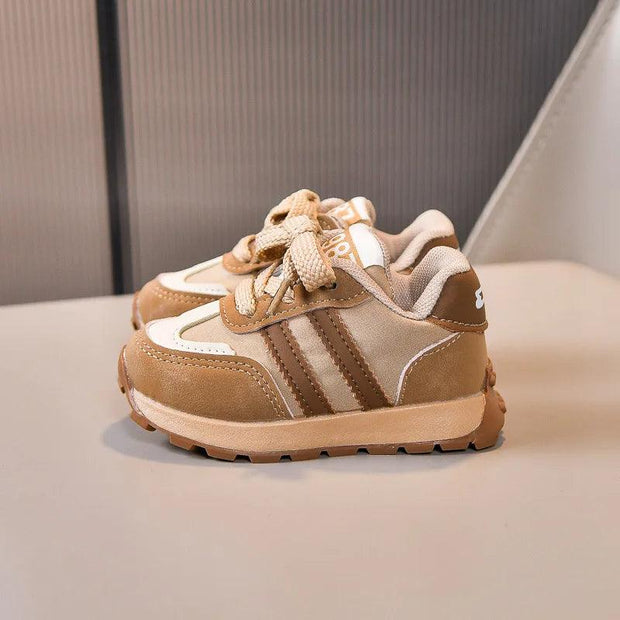 Two beige kids' sneakers with brown stripes, white details, and cream laces.